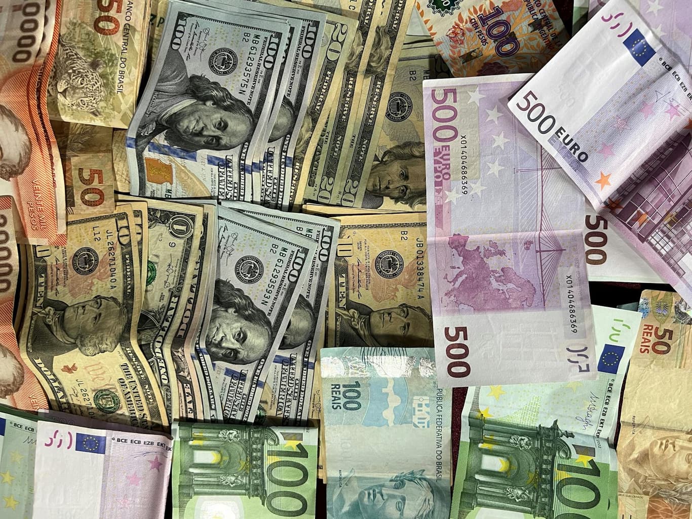 Euro, US dollar, British pound, and Swiss franc banknotes representing multi-currency accounts