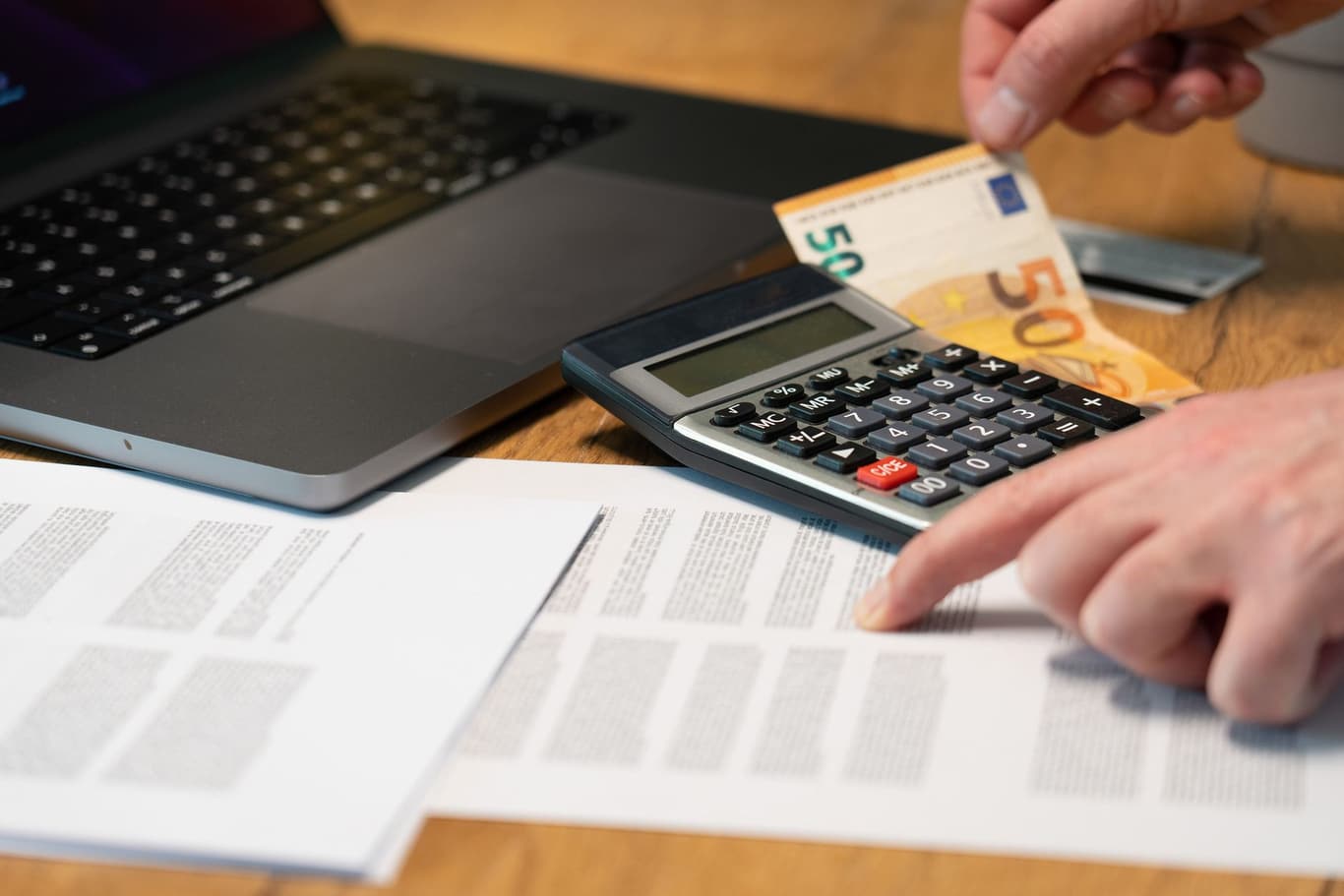 Corporate financial documents and multi-currency accounts on executive desk