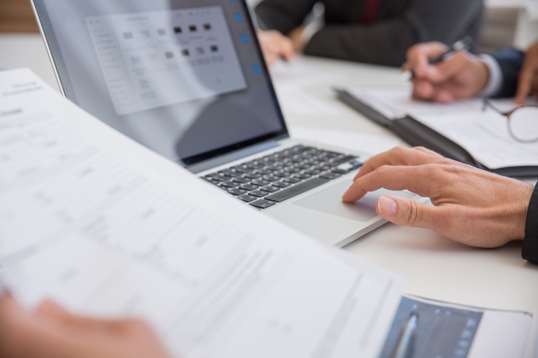 Financial documents and laptop on desk during account review process