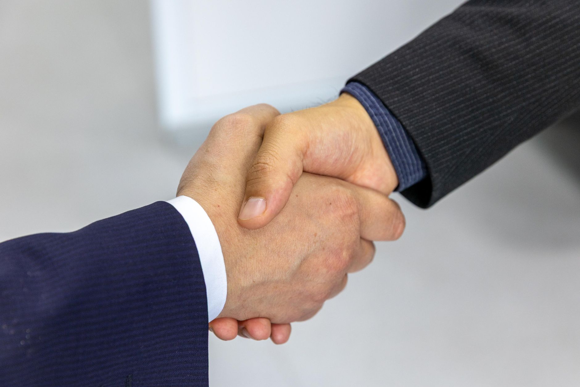 Business people shaking hands after contract signing—dedicated account manager