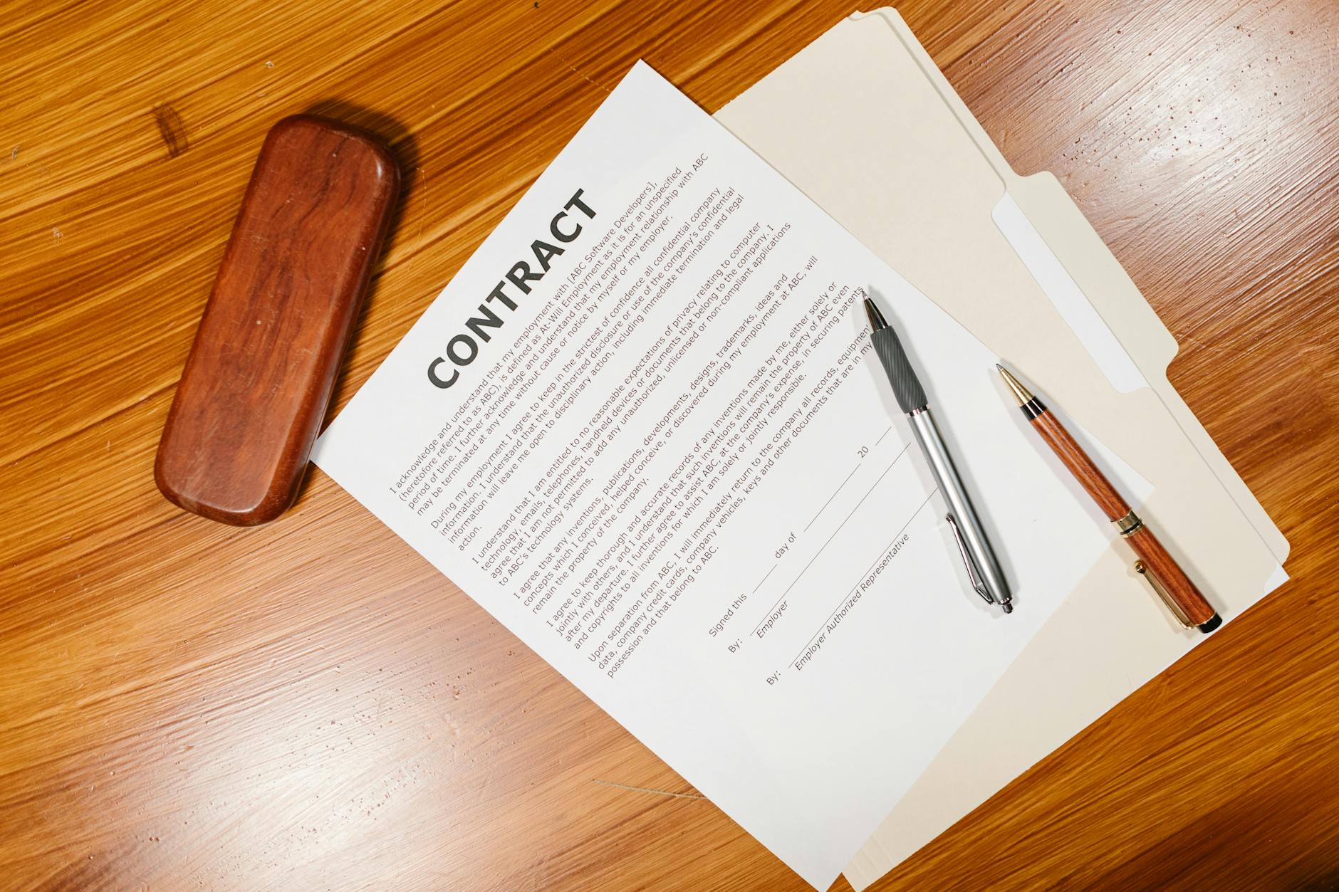Corporate documents and contracts on desk symbolizing due diligence requirements