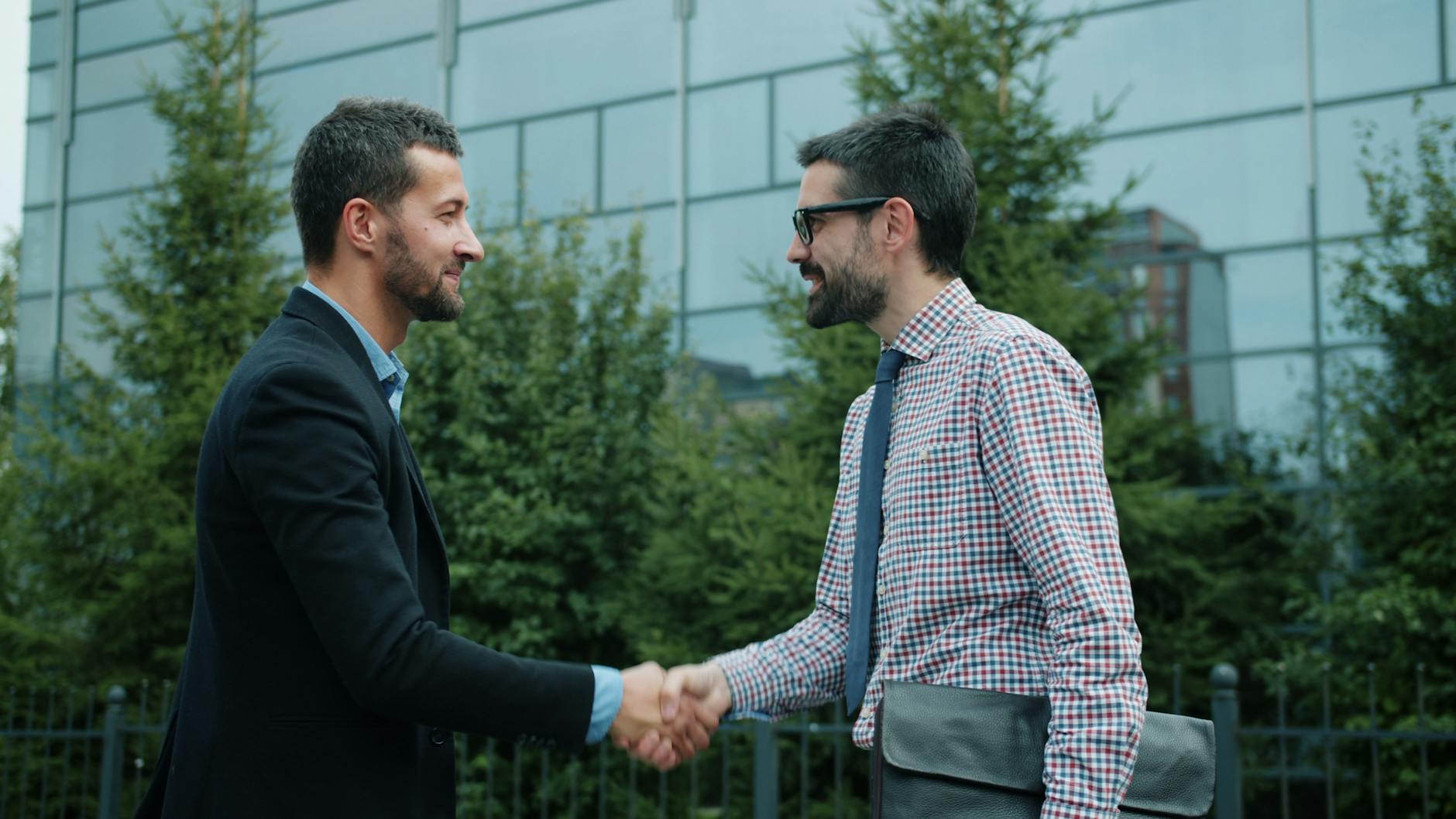 Business professionals shaking hands in office during partnership meeting