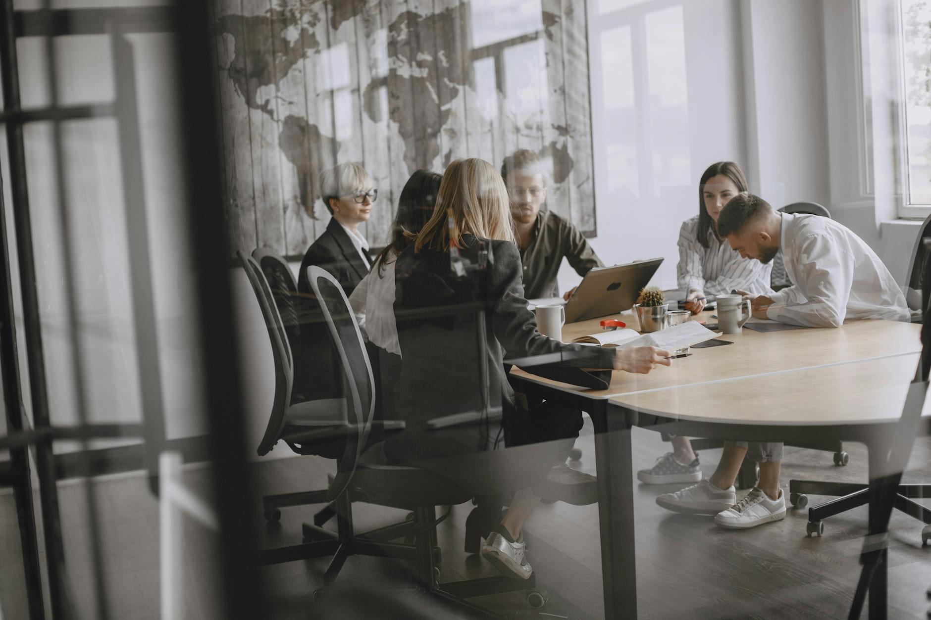 Affiliate network operations team reviewing mass payout schedules at office desk