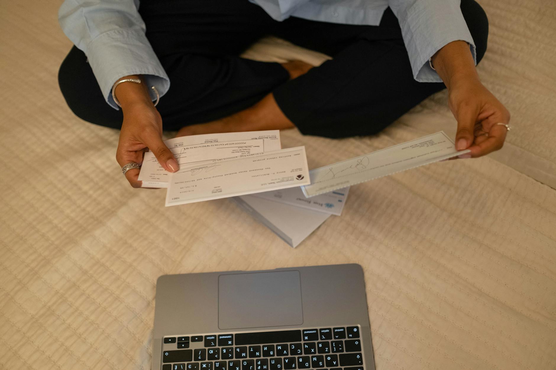 Corporate finance documents and laptop showing multi-currency account management