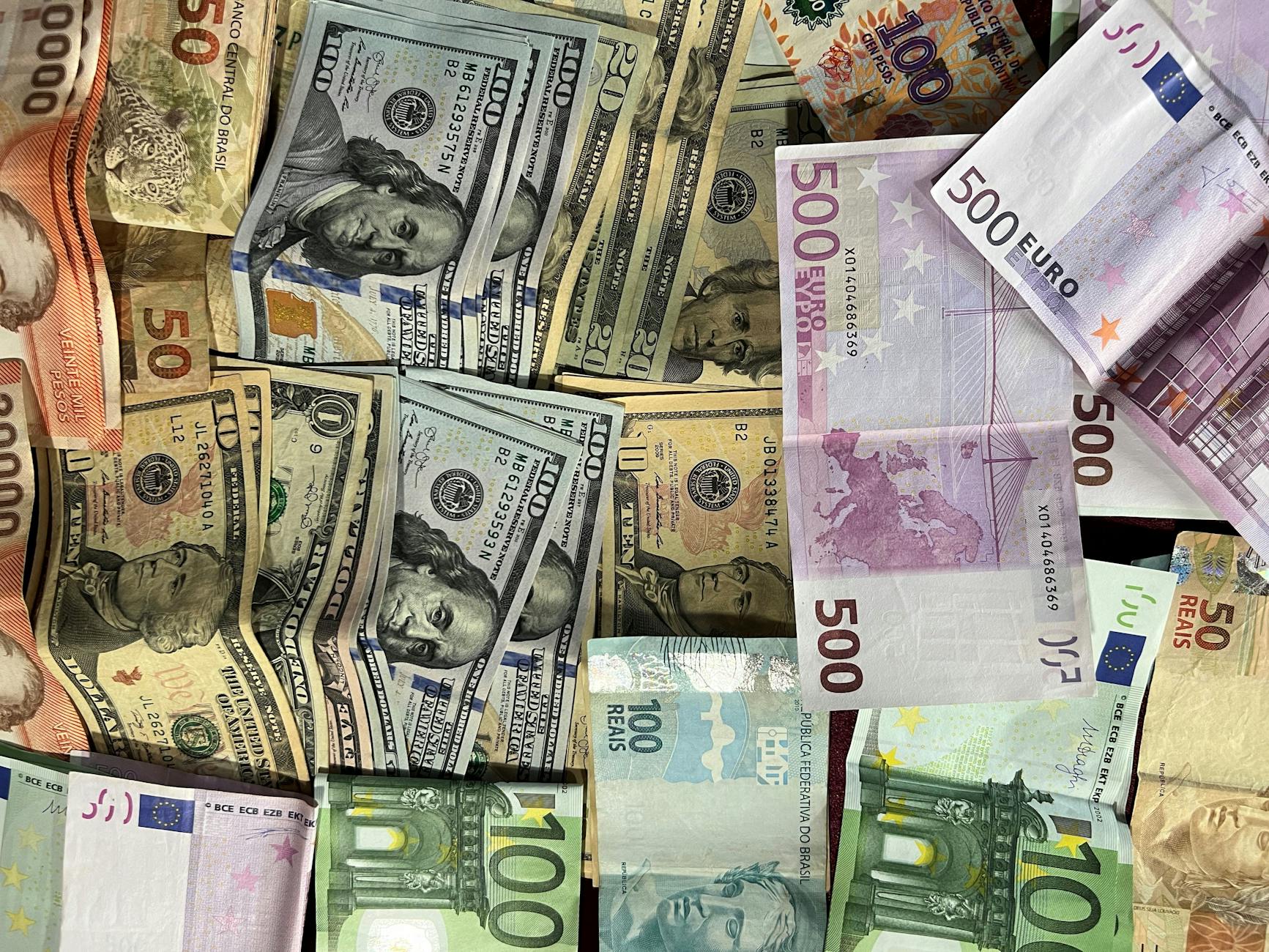 Euro, US dollar, British pound, and Swiss franc banknotes representing multi-currency accounts