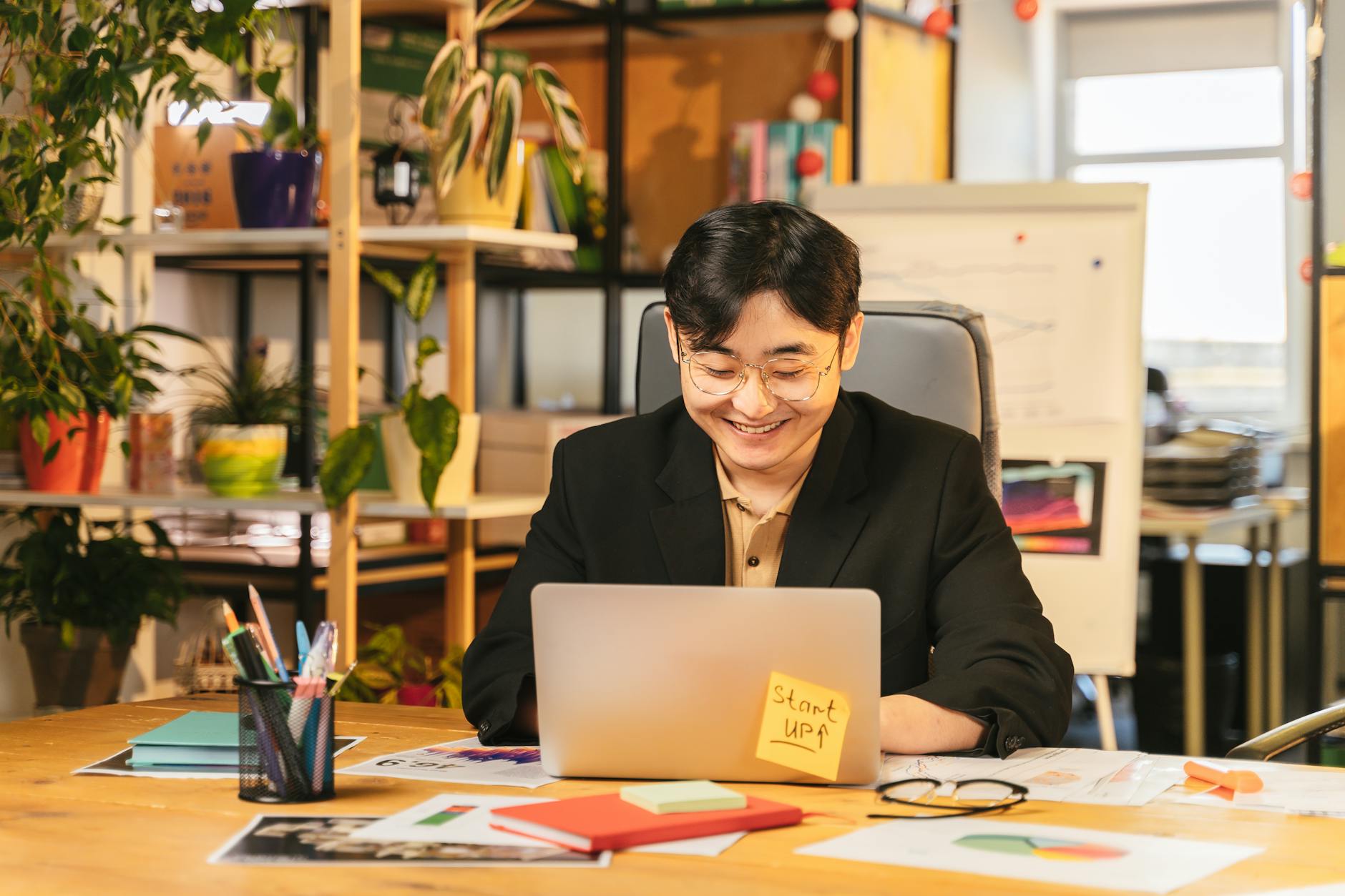 Entrepreneur reviewing financial accounts on laptop in modern office