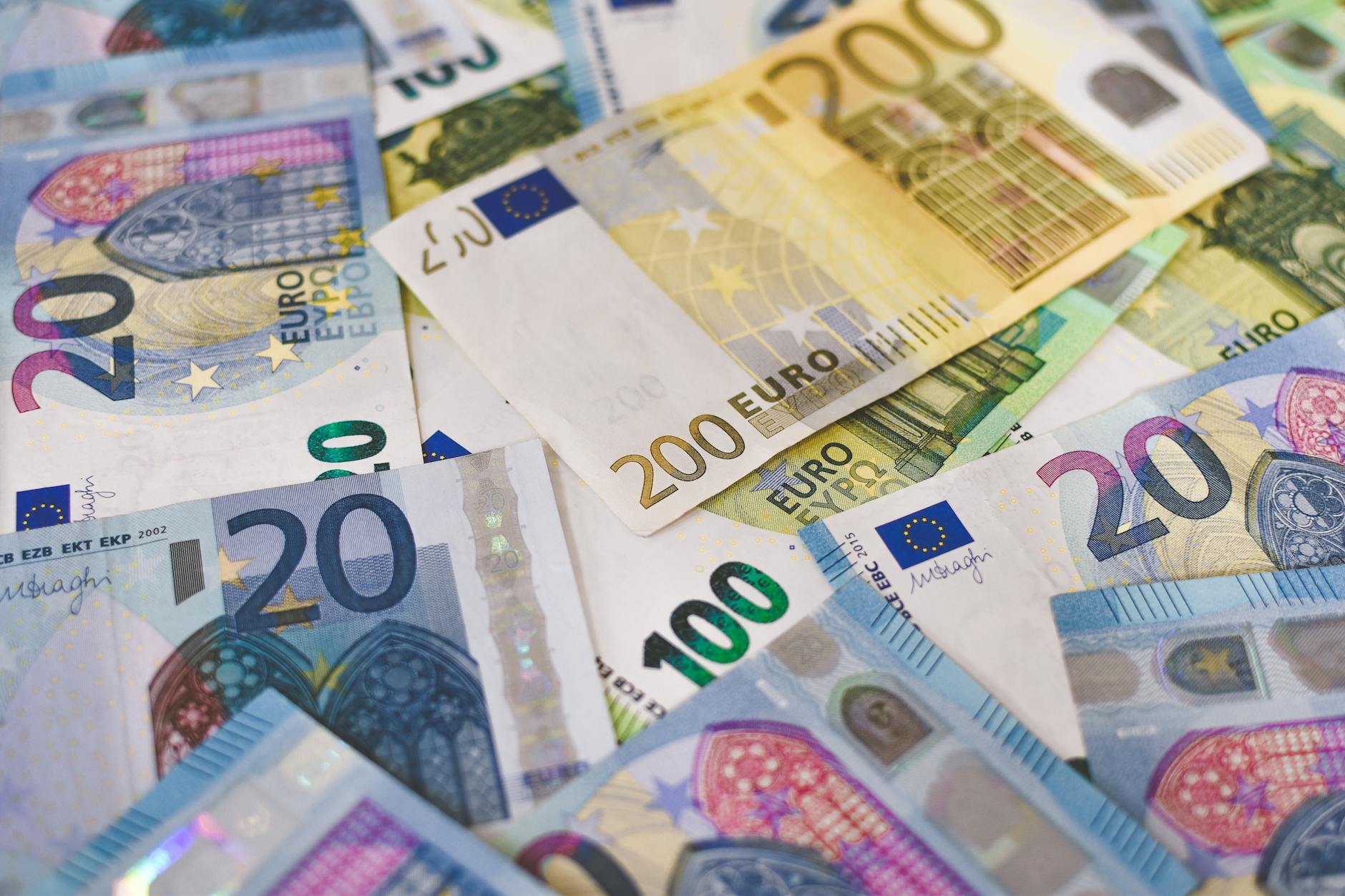 Euro banknotes and currency exchange documents on a business desk