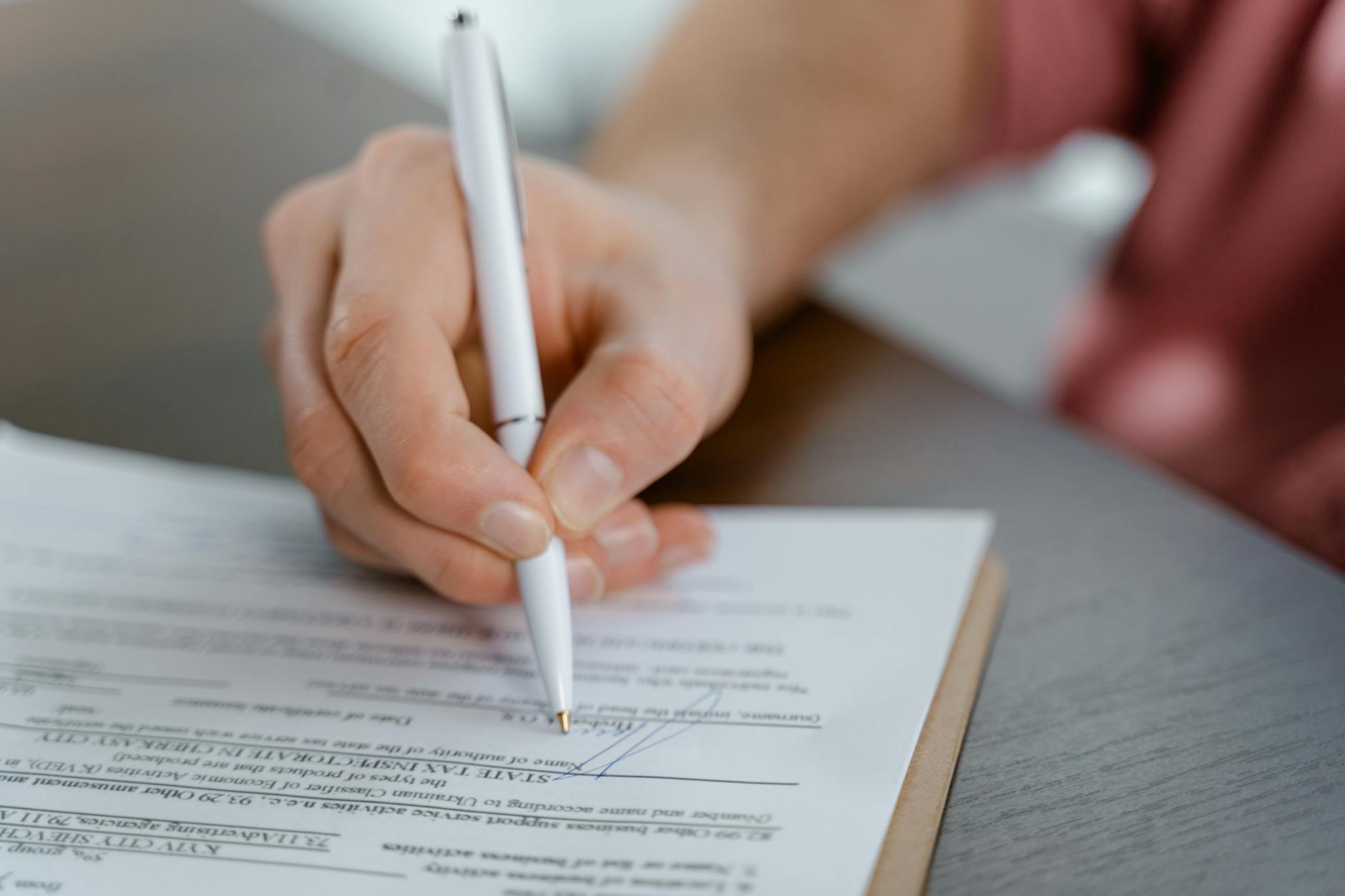 Business professional reviewing and signing corporate account agreement
