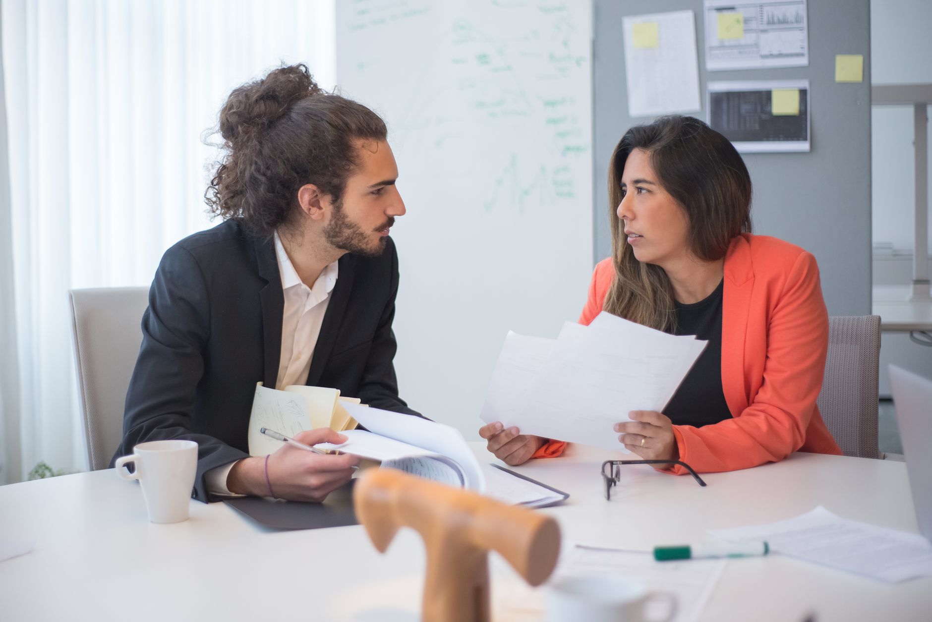 European business professionals reviewing documents in a modern corporate office
