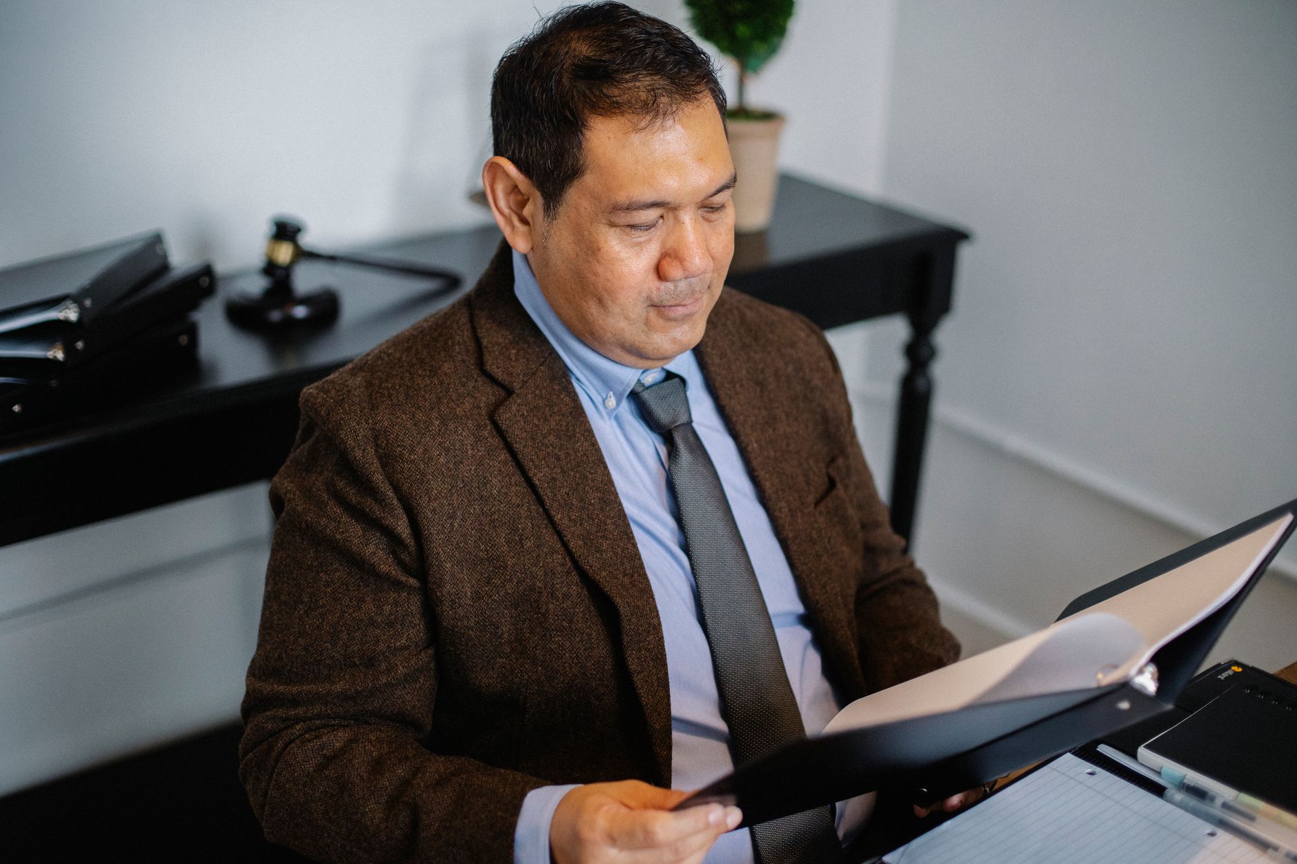 Business professional analyzing corporate banking documents and compliance paperwork